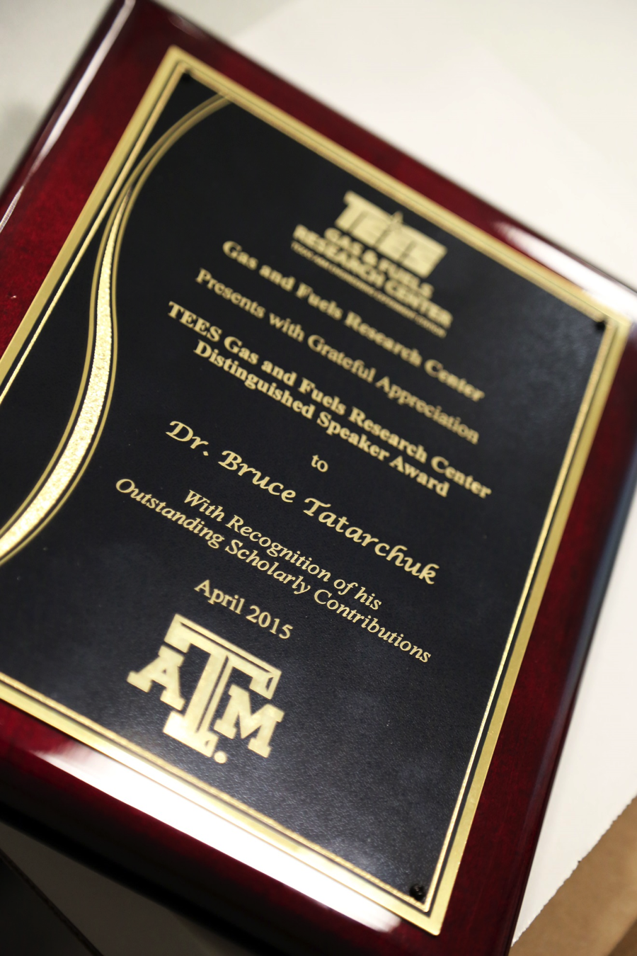 TEES Gas and Fuels Research Center Distinguished Speaker Award plaque to Dr. Bruce Tartarchuk